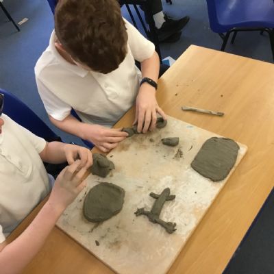Children making clay lizards